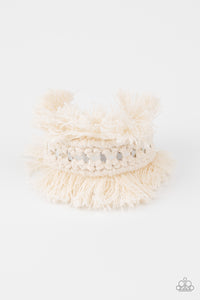 Twine-like thread decoratively knots around an airy silver cuff, creating a macramé inspired fringe around the wrist.  Sold as one individual bracelet.