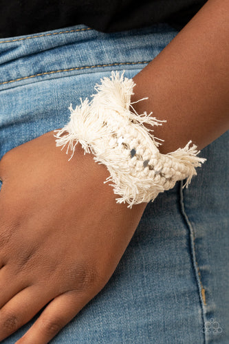 Twine-like thread decoratively knots around an airy silver cuff, creating a macramé inspired fringe around the wrist.  Sold as one individual bracelet.