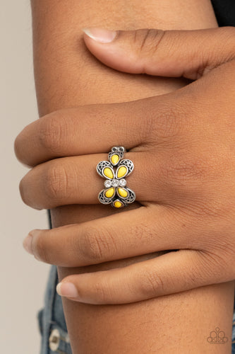 Featuring a white rhinestone encrusted center, a yellow beaded silver butterfly adorns the finger for a colorfully whimsical look. Features a dainty stretchy band for a flexible fit.  Sold as one individual ring.