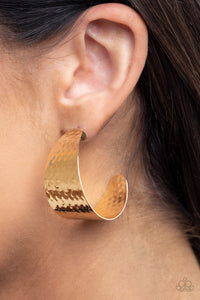 Delicately hammered in a shimmery finish, a flat gold frame curls into a curvy hoop for a chic finish. Earring attaches to a standard post fitting. Hoop measures approximately 1 1/2" in diameter.  Sold as one pair of hoop earrings.