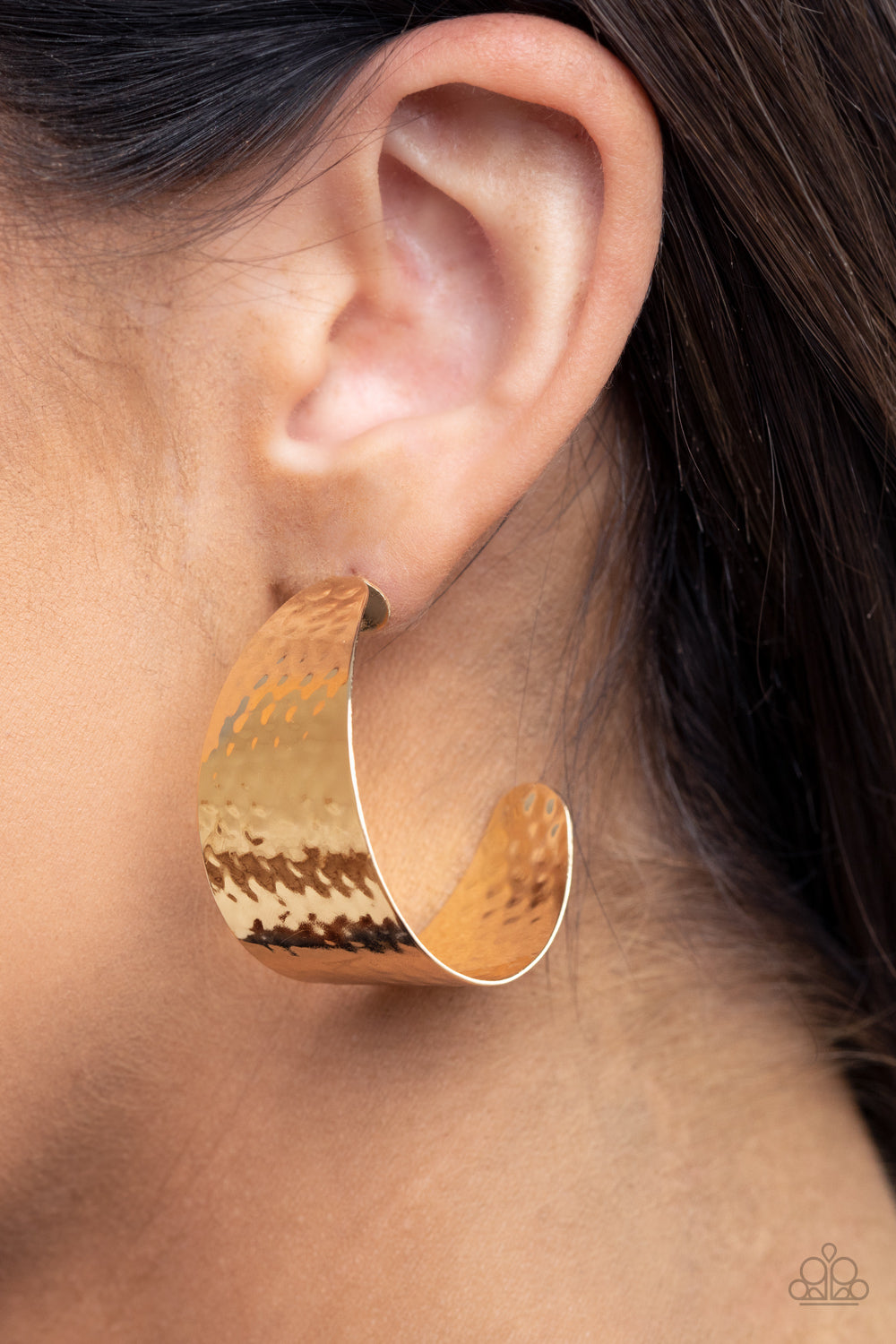 Delicately hammered in a shimmery finish, a flat gold frame curls into a curvy hoop for a chic finish. Earring attaches to a standard post fitting. Hoop measures approximately 1 1/2