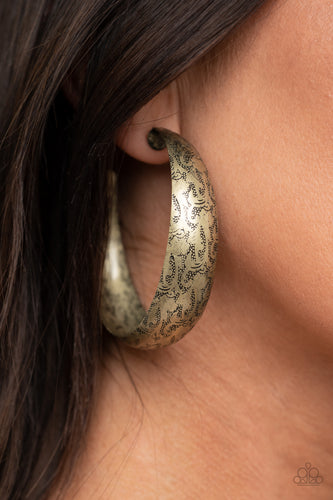 Delicately hammered in studded-like patterns, an oversized antiqued brass hoop boldly curls around the ear for a whimsically rustic look. Earring attaches to a standard post fitting. Hoop measures approximately 2