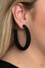 Load image into Gallery viewer, Earthy black twine-like cording is wrapped around a thick hoop, creating a colorful rustic display. Earring attaches to a standard post fitting. Hoop measures approximately 2 1/4&quot; in diameter.  Sold as one pair of hoop earrings.
