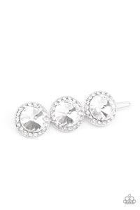 Encrusted in glassy white rhinestones, a trio of oversized white gems coalesce into a blinding centerpiece. Features a clamp barrette closure.  Sold as one individual hair clip.