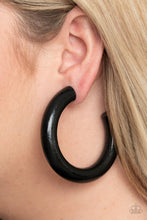 Load image into Gallery viewer, Painted in a shiny black finish, a thick wooden frame dramatically curls into an oversized hoop for a colorfully retro look. Earring attaches to a standard post fitting. Hoop measures approximately 2 1/2" in diameter.  Sold as one pair of hoop earrings.
