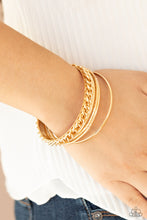 Load image into Gallery viewer, Pairs of smooth and textured gold bangles join a gold bangle around the wrist that is decorated in a single strand of gold chain for a gritty finish.  Sold as one set of five bracelets.
