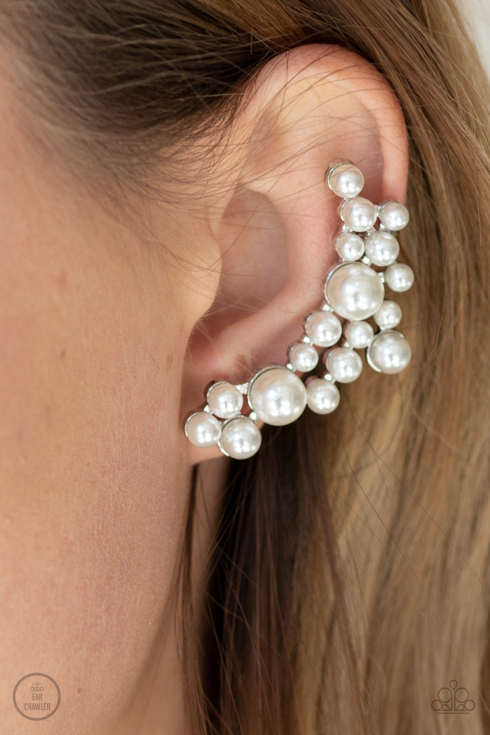 A collection of bubbly white pearls dot a shiny silver frame that branches up the ear for a modern, timeless twist. Earring attaches to a standard post fitting. Features a clip-on fitting at the top for a secure fit.  Sold as one pair of ear crawlers.