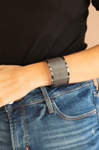 Twisted rows of gunmetal wire layer between two flat gunmetal bars, coalescing into a boldly stacked cuff around the wrist.  Sold as one individual bracelet.