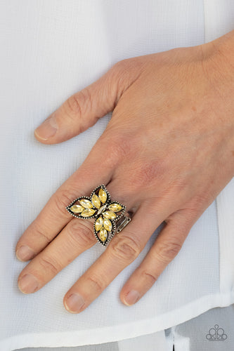 The wings of a studded silver butterfly have been adorned in glittery yellow marquise rhinestones, creating a glamorous centerpiece atop the finger. Features a stretchy band for a flexible fit.  Sold as one individual ring.