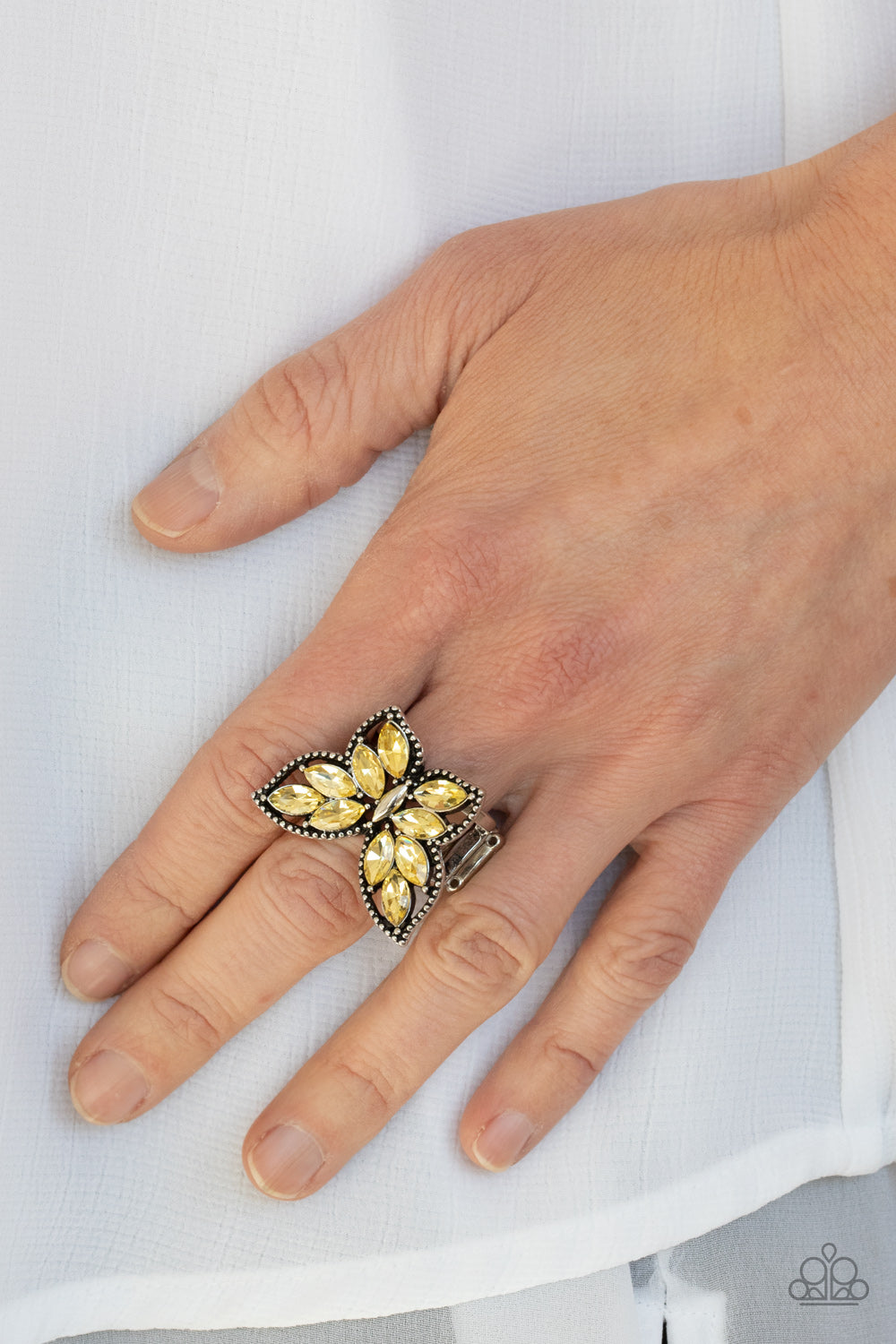 The wings of a studded silver butterfly have been adorned in glittery yellow marquise rhinestones, creating a glamorous centerpiece atop the finger. Features a stretchy band for a flexible fit.  Sold as one individual ring.