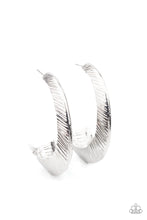Load image into Gallery viewer, Etched in sporadic linear patterns, two shimmery silver frames join into a hollow hook that flares out into an eye-catching hoop. Earring attaches to a standard post fitting. Hoop measures approximately 1 1/2&quot; in diameter.  Sold as one pair of hoop earrings.
