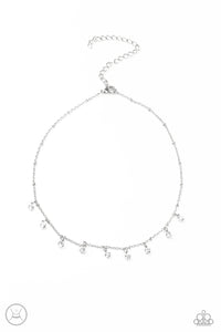 Glassy white rhinestones swing from a dainty silver chain, creating a glamorous fringe around the neck. Features an adjustable clasp closure.  Sold as one individual choker necklace. Includes one pair of matching earrings.