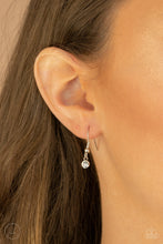 Load image into Gallery viewer, White rhinestone hanging from a silver fish hook earring.
