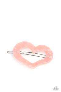 Flecked in iridescent shell-like shimmer, a pink acrylic heart frame pulls back the hair in a flirty fashion. Features a clamp barrette closure.  Sold as one individual Barrette.