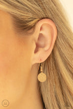 Load image into Gallery viewer, Gold hammered disc hanging from a gold fish hook earring.
