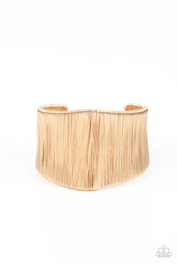 A seemingly infinite collection of shimmery gold wire wraps around the a substantial gold cuff, creating a bold industrial inspired centerpiece around the wrist.  Sold as one individual bracelet.