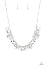 Load image into Gallery viewer, An oversized collection of white emerald cut gems and regally cut clusters of rhinestones delicately link below the collar, creating a dramatically sparkly fringe. Features an adjustable clasp closure.  Sold as one individual necklace. Includes one pair of matching earrings. 
