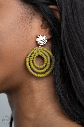 A hammered gold disc attaches to rippling hoops wrapped in green wicker-like cording, creating an earthy lure. Earring attaches to a standard clip-on fitting.  Sold as one pair of clip-on earrings.