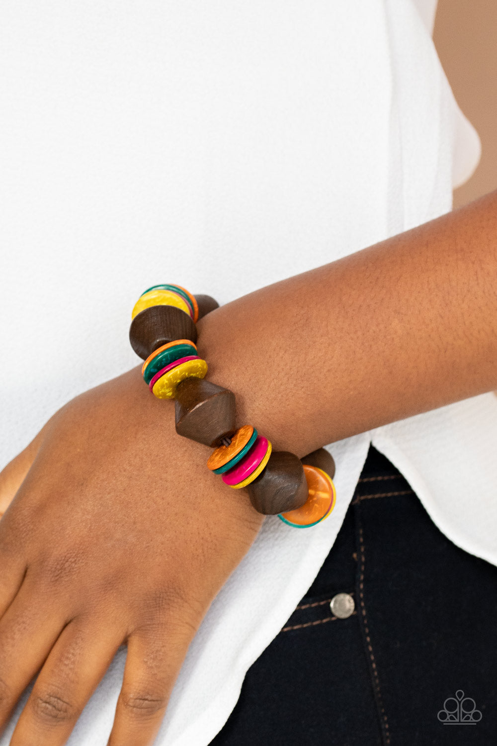 Multicolored wooden discs and chunky brown wooden beads are threaded along a stretchy band around the wrist, creating a summery look.  Sold as one individual bracelet.