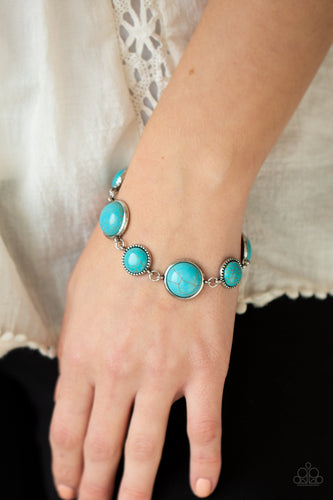 Featuring studded and plain silver frames, small and large turquoise stones delicately alternate around the wrist for a rustic flair. Features an adjustable clasp closure.