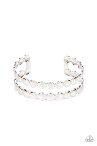 Brushed in a shiny finish, rows of flattened silver studs coalesce into a shimmery cuff around the wrist.  Sold as one individual bracelet.