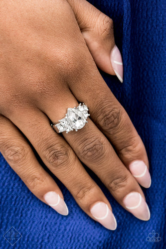 Trios of glassy white rhinestones flank an oversized white teardrop rhinestone, creating a sparkly centerpiece atop a dainty silver band. Features a dainty stretchy band for a flexible fit.  Sold as one individual ring.
