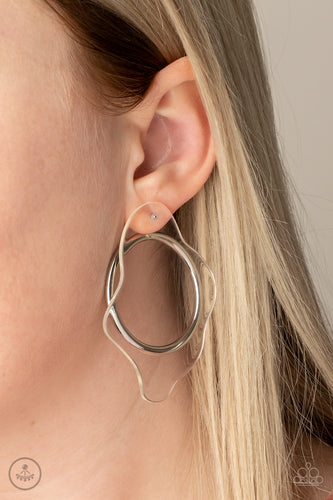 A warped piece of clear acrylic attaches to a double-sided post, while an oversized silver hoop peeks out beneath the ear for a bold look. Earring attaches to a standard post fitting.  Sold as one pair of double-sided post earrings.