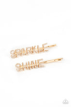 Load image into Gallery viewer, Glassy white rhinestones spell out &quot;Sparkle,&quot; and &quot;Shine,&quot; across the fronts of two gold bobby pins, creating a sparkly duo.  Sold as one pair of decorative bobby pins.
