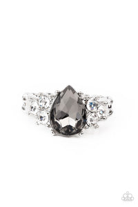 Trios of glassy white rhinestones flank an oversized smoky teardrop rhinestone, creating a sparkly centerpiece atop a dainty silver band. Features a dainty stretchy band for a flexible fit.  Sold as one individual ring.