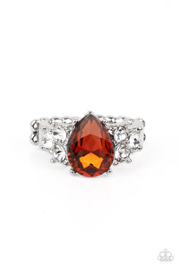 Trios of glassy white rhinestones flank an oversized teardrop topaz rhinestone, creating a sparkly centerpiece atop a dainty silver band. Features a dainty stretchy band for a flexible fit.  Sold as one individual ring.