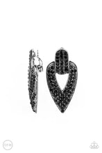 Load image into Gallery viewer, The front of a spade shaped silver frame is encrusted in row after row of glittery black rhinestones, creating a blinding buckle inspired statement piece. Earring attaches to a standard clip-on fitting.  Sold as one pair of clip-on earrings.
