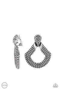 Dotted in rows of studded details, an oversized silver buckle-like frame adorns the ear for a rustic fashion. Earring attaches to a standard clip-on fitting.  Sold as one pair of clip-on earrings.