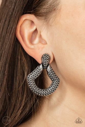 Dotted in rows of studded details, an oversized silver buckle-like frame adorns the ear for a rustic fashion. Earring attaches to a standard clip-on fitting.  Sold as one pair of clip-on earrings.