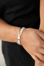 Load image into Gallery viewer, A flat silver bar delicately curls across a dainty white shell-like acrylic cuff, creating a whimsical centerpiece around the wrist.  Sold as one individual bracelet.
