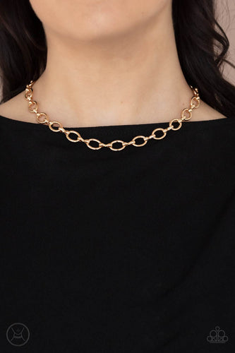 A collection of oversized gold ovals and glistening gold fittings interlock around the neck, creating an intense industrial look. Features an adjustable clasp closure.  Sold as one individual choker necklace. Includes one pair of matching earrings.   
