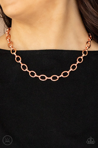 A collection of oversized shiny copper ovals and shiny copper fittings interlock around the neck, creating an intense industrial look. Features an adjustable clasp closure.  Sold as one individual choker necklace. Includes one pair of matching earrings.