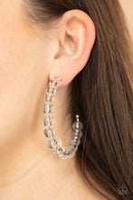 Load image into Gallery viewer, Gradually increasing in size at the center, a glassy collection of white beads are threaded along an oversized hoop for a bubbly effect. Earring attaches to a standard post fitting. Hoop measure approximately 2 1/2&quot; in diameter.  Sold as one pair of hoop earrings.
