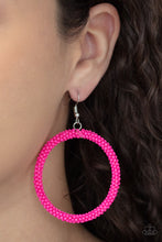 Load image into Gallery viewer, A dainty strand of vivacious pink seed beads wrap around a silver hoop, creating a bubbly hoop. Earring attaches to a standard fishhook fitting.  Sold as one pair of earrings.
