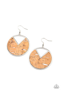 Featuring hints of white accents, an earthy piece of cork is placed into the center of a circular hoop. A triangular slice is removed from the cork, creating an edgy airy finish. Earring attaches to a standard fishhook fitting.  Sold as one pair of earrings.
