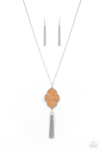 Flecked in glittery silver sparkles, a scalloped cork frame is pressed into a sleek silver frame at the bottom of a dainty silver satellite chain. A classic silver chain tassel swings from the whimsical pendant, adding flirtatious movement to the one-of-a-kind display. Features an adjustable clasp closure.  Sold as one individual necklace. Includes one pair of matching earrings.