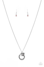 Load image into Gallery viewer, Dotted with a sparkly pink rhinestone, a dainty silver heart joins a silver ring stamped in the biblical passage, &quot;Trust in the Lord with all thine heart,&quot; and a silver disc stamped in, &quot;Proverbs 3:5,&quot; along the bottom of a lengthened silver chain, creating an inspirational pendant. Features an adjustable clasp closure.  Sold as one individual necklace. Includes one pair of matching earrings.
