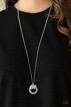 Load image into Gallery viewer, Dotted with a sparkly pink rhinestone, a dainty silver heart joins a silver ring stamped in the biblical passage, &quot;Trust in the Lord with all thine heart,&quot; and a silver disc stamped in, &quot;Proverbs 3:5,&quot; along the bottom of a lengthened silver chain, creating an inspirational pendant. Features an adjustable clasp closure.  Sold as one individual necklace. Includes one pair of matching earrings.

