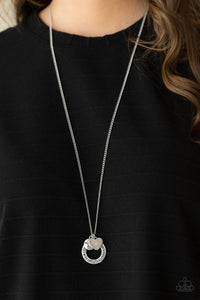 Dotted with a sparkly pink rhinestone, a dainty silver heart joins a silver ring stamped in the biblical passage, "Trust in the Lord with all thine heart," and a silver disc stamped in, "Proverbs 3:5," along the bottom of a lengthened silver chain, creating an inspirational pendant. Features an adjustable clasp closure.  Sold as one individual necklace. Includes one pair of matching earrings.