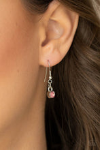 Load image into Gallery viewer, Pink rhinestone hanging from a silver fish hook earring.
