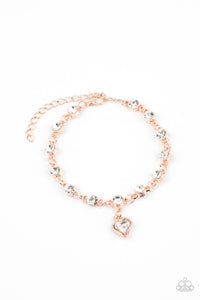 Brilliant white rhinestones in rose gold settings are linked together and accented with a charming white rhinestone heart that dangles sweetly from the wrist. Features an adjustable clasp closure.  Sold as one individual bracelet.