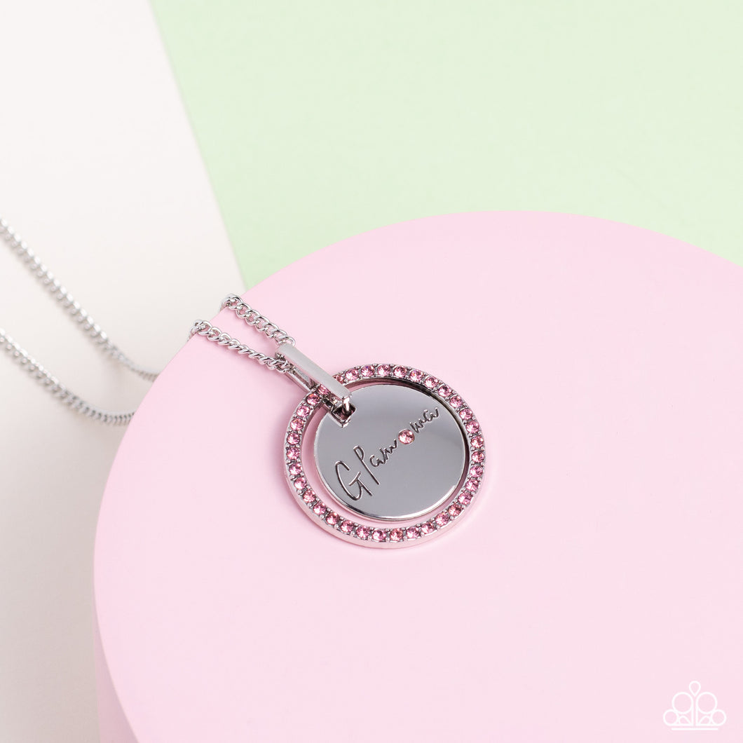 Infused with a silver ring of glassy pink rhinestones, a glistening silver disc is dotted with dainty pink rhinestone and stamped in the word, 