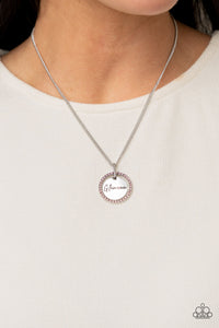 Infused with a silver ring of glassy pink rhinestones, a glistening silver disc is dotted with dainty pink rhinestone and stamped in the word, "Glamma," as it swings below the collar for a glamorously sentimental look. Features an adjustable clasp closure.  Sold as one individual necklace. Includes one pair of matching earrings.