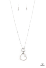 Load image into Gallery viewer, A silver heart engraved with the word &quot;Grandma,&quot; dangles from two smaller hearts at the bottom of a lengthened silver chain. The first heart is accented with sparkly white rhinestones creating an affectionately sentimental pendant. Features an adjustable clasp closure.  Sold as one individual necklace. Includes one pair of matching earrings.
