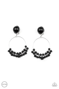 Shiny black beads are threaded along a dainty wire hoop that attaches to an oversized black beaded fitting, creating a bubbly fringe. Earring attaches to a standard clip-on fitting.  Sold as one pair of clip-on earrings.