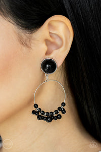 Shiny black beads are threaded along a dainty wire hoop that attaches to an oversized black beaded fitting, creating a bubbly fringe. Earring attaches to a standard clip-on fitting.  Sold as one pair of clip-on earrings.